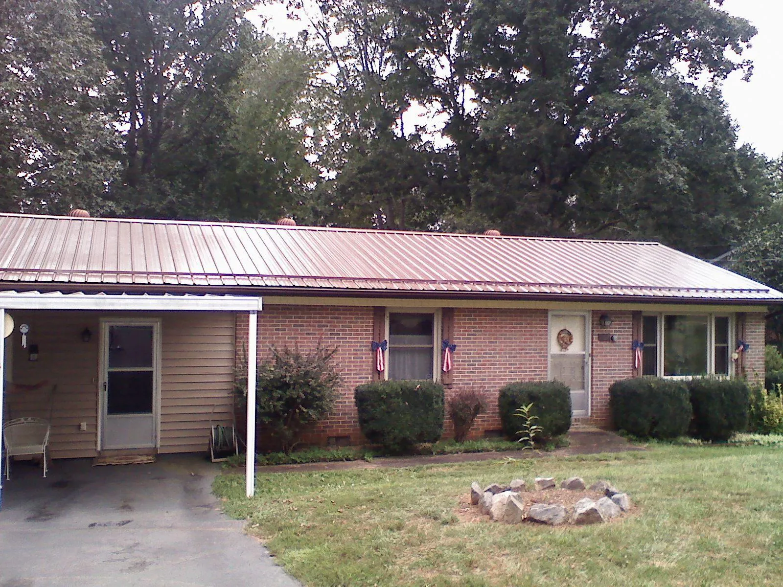 Bronze metal roof and carport on a brick ranch home — Roof Repair work by our crew in Tariffville